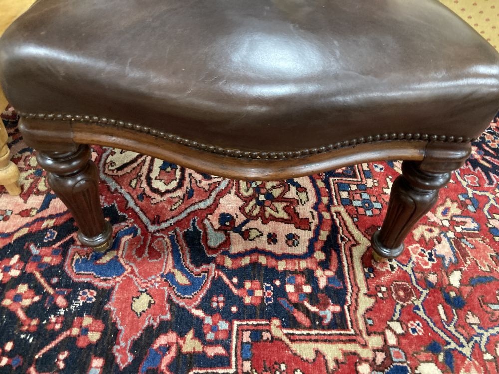 A Victorian mahogany and brown leather library chair